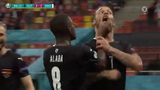 David Alaba grabbed Marko Arnautovic's face to try and shut up after his goal for Austria